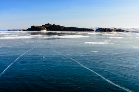 View of beautiful drawings on ice from cracks and bubbles of deep gas on surface of Baikal lake in...