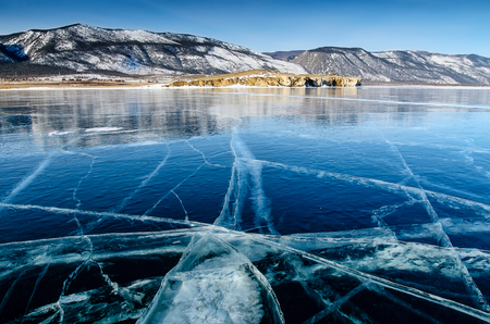 View of beautiful drawings on ice from cracks and bubbles of deep gas on surface of Baikal lake in winter, Russiaの写真素材