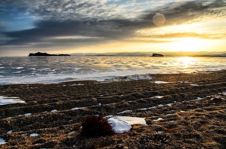 Frozen Lake Baikal. Beautiful stratus clouds over the ice surface on a frosty day.の写真素材