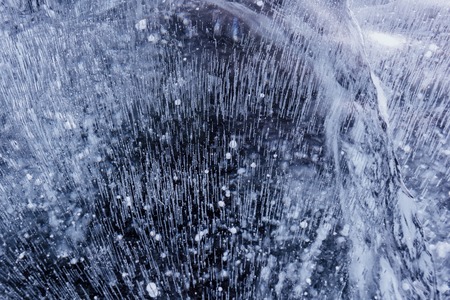 Blue cracked surface of the ice surfaceの写真素材