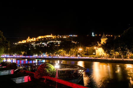 Night city reflected in Kura River in Tblisi, Georgia