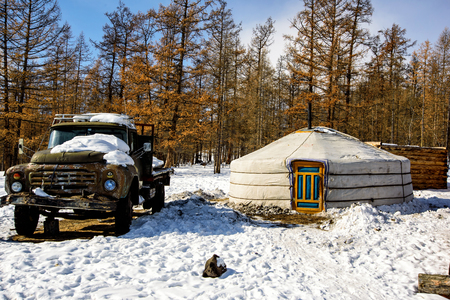 Khanh, Mongolia, Febrary, 24, 2018. Old wooden house in winter Mongolia near forest with old big russian trackのeditorial素材