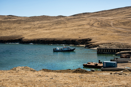 Sakhurta, Russia - May 1, 2018: Ferry is coming from the island of Olkhon. Lake Baikal in sunny day. The strait is called the Olkhon Gate.のeditorial素材