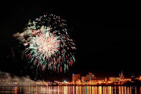 Long Exposure of Fireworks Reflecting on Calm Rippling Waterの写真素材