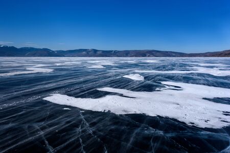 Frozen Lake Baikal. Beautiful mountain near the ice surface on a frosty day. Natural background