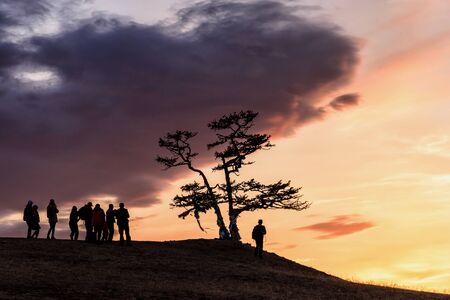 Lake Baikal, tree and people silhouette with beautiful sky and clouds, Russia Oklhon island