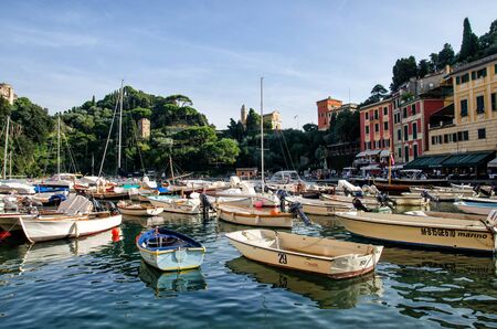 Italy, Portofino - October 3, 2014: Boats on water in the picturesque bay of Portofino with the view over the colorful housesのeditorial素材