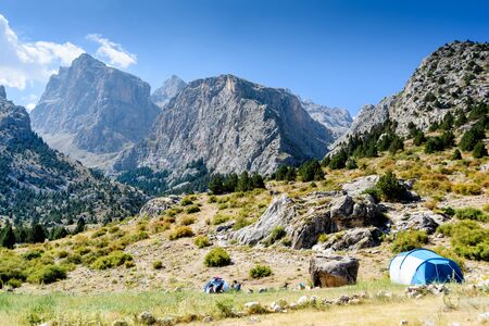 Turkey, Chamard - August 3, 2019: Mountain landscape with trees, tents and tourists in the Turkish national Park aladag in summer dayのeditorial素材