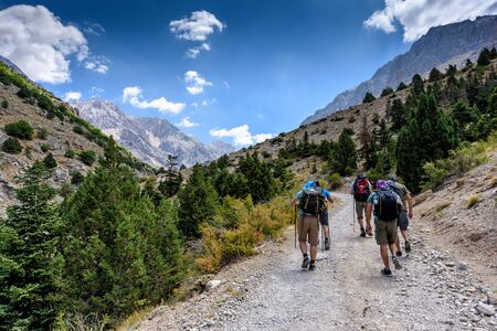 Turkey, Chamard - August 3, 2019: Tourists walk along the road through the mountain landscape in the Turkish national Park aladag in summer day, view from the backのeditorial素材