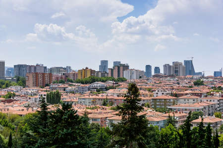 Ankara, Turkey - July 24, 2018: View above of Ankara houses with tiled roofs and skyscrapers in...