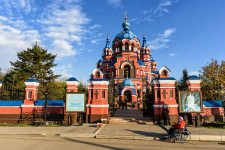 Irkutsk, Russia - October 8, 2019: A woman in a wheelchair begs near the Orthodox Church of lady of Kazanのeditorial素材