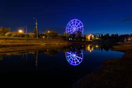 Russia, Irkutsk - June 13, 2020: Colorfull abstract Ferris wheel with reflection on the Konny island in Irkutsk cityのeditorial素材