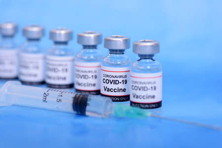 Vaccine and Healthcare Medical concept. Vaccines and syringe on blue background for prevention,immunization and treatment from corona virus infectionの写真素材