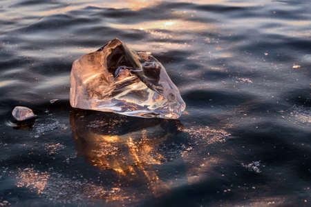 Ice floe and sun on winter Baikal lake