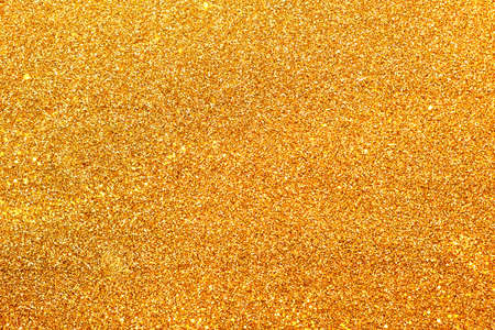 Shiny gold sparkles glitter background for new year, Christmas, wedding design of invitations and postcards with copy spaceの写真素材