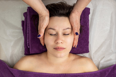 Facial massage. Close-up of an adult woman getting a spa massage at a beauty spa