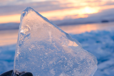 Lake Baikal in winter covered with ice and snow texture in sunset evening, Russia, Siberiaの写真素材