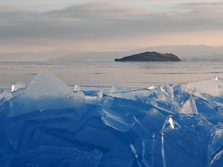 Lake Baikal in winter covered with ice and snow texture in sunset evening, Russia, Siberiaの写真素材