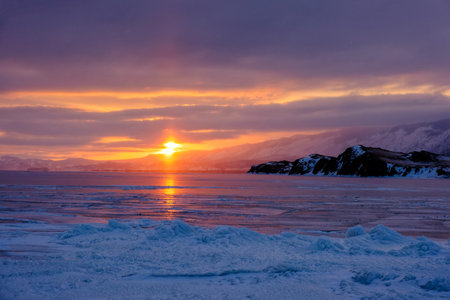 Lake Baikal in winter covered with ice and snow texture in sunset evening, Russia, Siberiaの写真素材