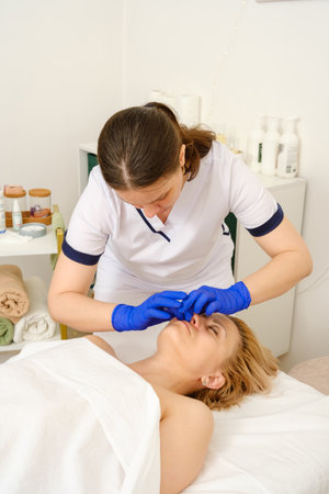Massage therapist gives woman oil massage.の写真素材