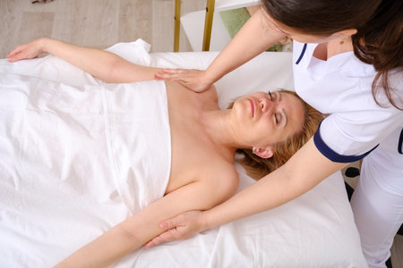 Massage therapist gives woman oil massage.の写真素材