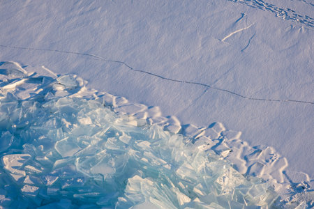 Endless hummock field on frozen Lake Baikal. Piles of snow-covered debris of blue ice on frosty day