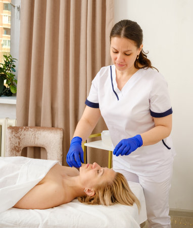 Massage therapist gives woman oil massage.の写真素材