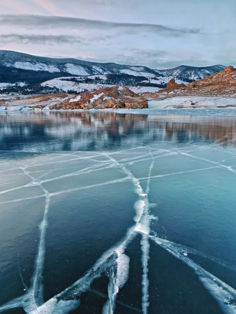 Baikal Lake in winter. Beautiful landscape with mountains reflected in ice of frozen Small Seaの写真素材