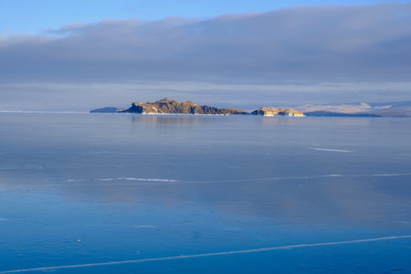 Baikal Lake in winter. Beautiful landscape with mountains reflected in ice of frozen Small Seaの写真素材