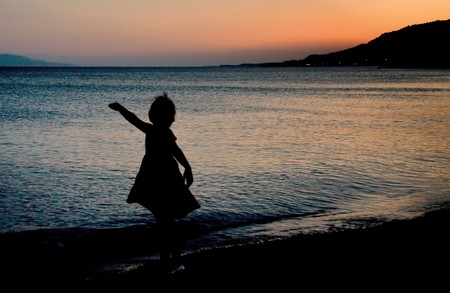 A little girl turning around like a balerina.の写真素材