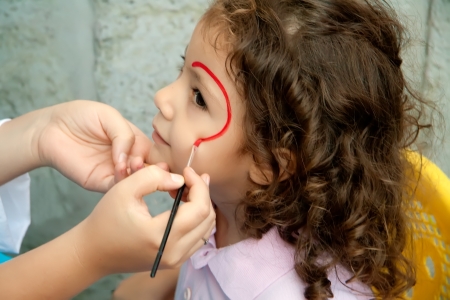 Little Girl Face Painted By An Artist At A Festival         の写真素材
