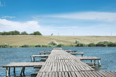 old wooden pier on a clean, deep lakeの写真素材