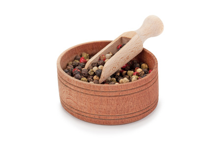 mixture of peppers and wooden utensils isolated on white backgroundの写真素材