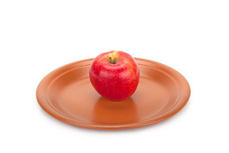 red apple on a plate isolated on white backgroundの写真素材