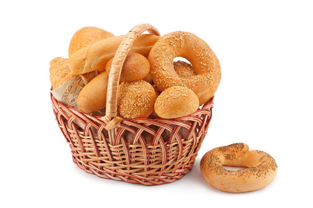 Composition with bread and rolls in wicker basket isolated on whiteの写真素材