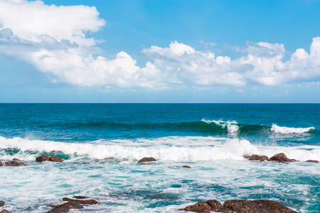 Turquoise ocean water ,blue sky and giant boulders on paradise beach.の写真素材