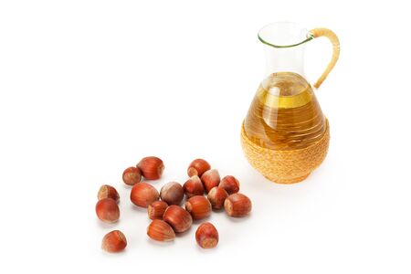 Hazelnut oil with nuts isolated on whiteの写真素材