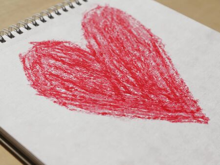 children's drawing with wax crayons in the form of a heartの写真素材