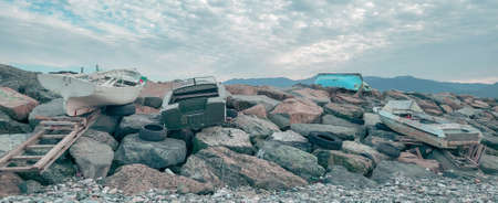 Old abandoned wooden fishing boats on the beach. A rocky beach on the Black Sea in Batumi, Georgiaの写真素材