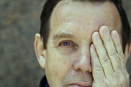 man covering left eye(special photo f/x,focus on the eye)