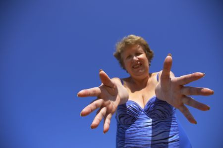 woman on the sky background (focus on the hands)の写真素材