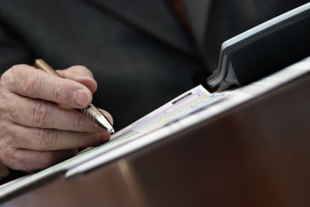 work with paper (focus point on the pen(special toned))の写真素材