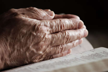 prayer (special toned film-grained photo f/x, focus selective on hand)の写真素材
