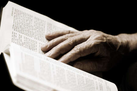 reading the Bible (special photo toned f/x, focus point on hand (selective))の写真素材