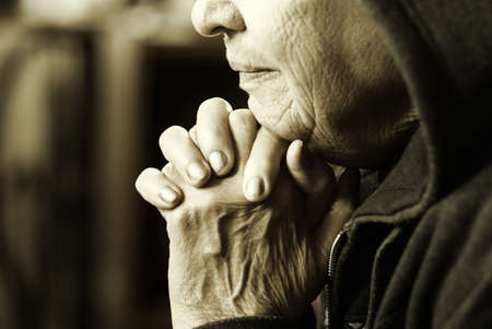 prayer (special sepia toned photo f/x, focus point on lips and fingers(selective))の写真素材