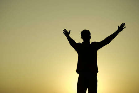 sunset with young man,special toned and color photo f/x, focus point on the manの写真素材