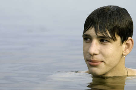 wet cute young adult in the water (focus point on eye)