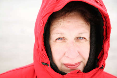 happy woman in red jacket with big hoodの写真素材