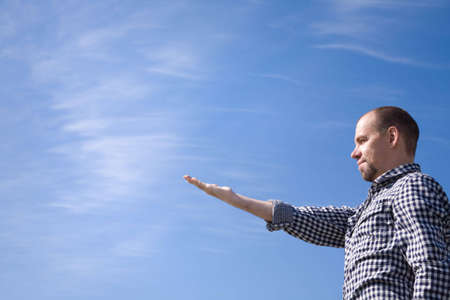 man on blue sky background with empty space for text or designの写真素材