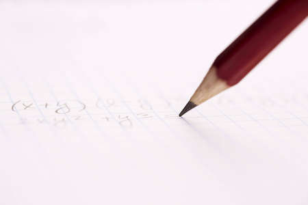 doing math ,selective focus on center of photo, writing part of penの写真素材